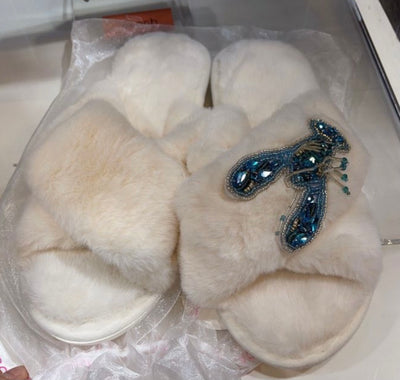 White fluffy slippers with teal lobster