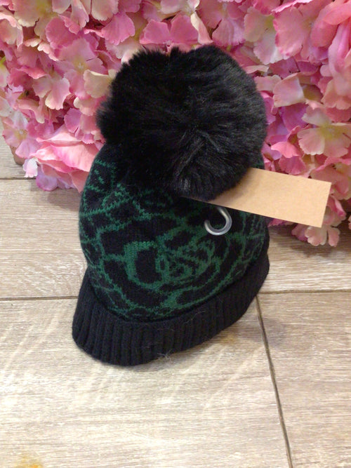 Black hat with green detail and fur lining